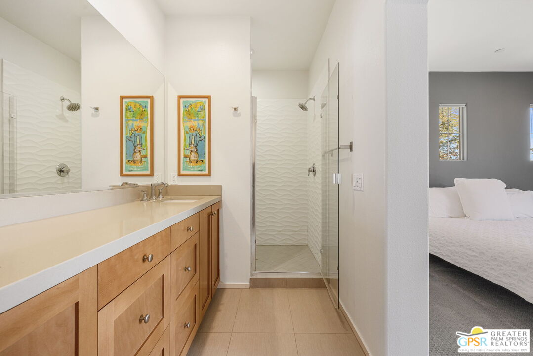 491 Terra Vita Palm Springs, CA 92262 - Photo 20 of 25 a bathroom with a shower sink and mirror