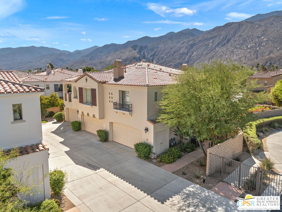 491 Terra Vita Palm Springs, CA 92262 - Photo 2 of 25 a view of a white house with a yard and potted plants