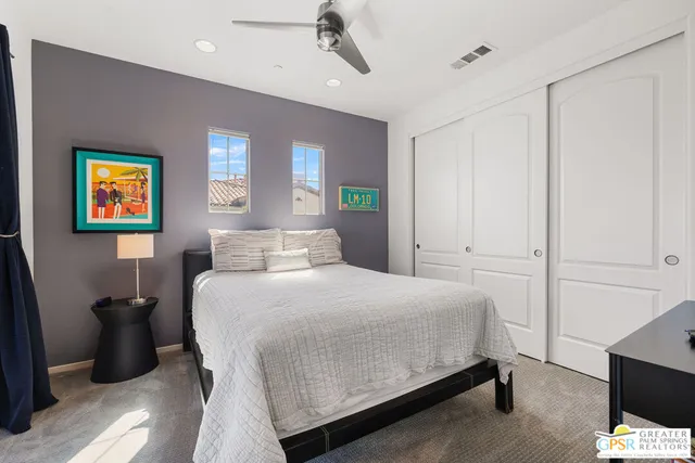 a bedroom with a large bed and a window