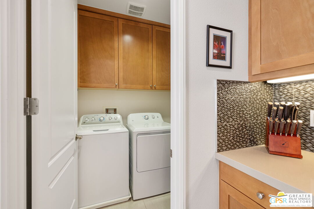 491 Terra Vita Palm Springs, CA 92262 - Photo 24 of 25 a view of storage and utility room with washer and dryer