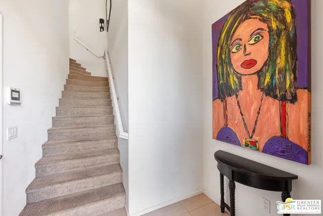 a living room with furniture a large window and table