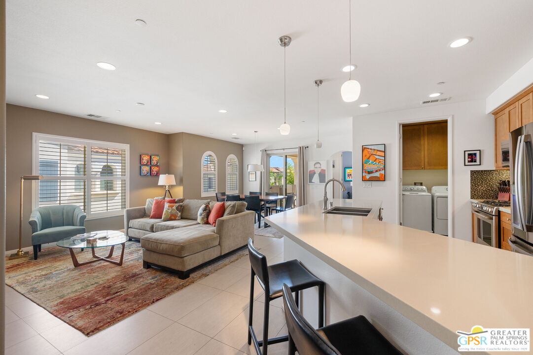 491 Terra Vita Palm Springs, CA 92262 - Photo 6 of 25 a living room with furniture a large window and table