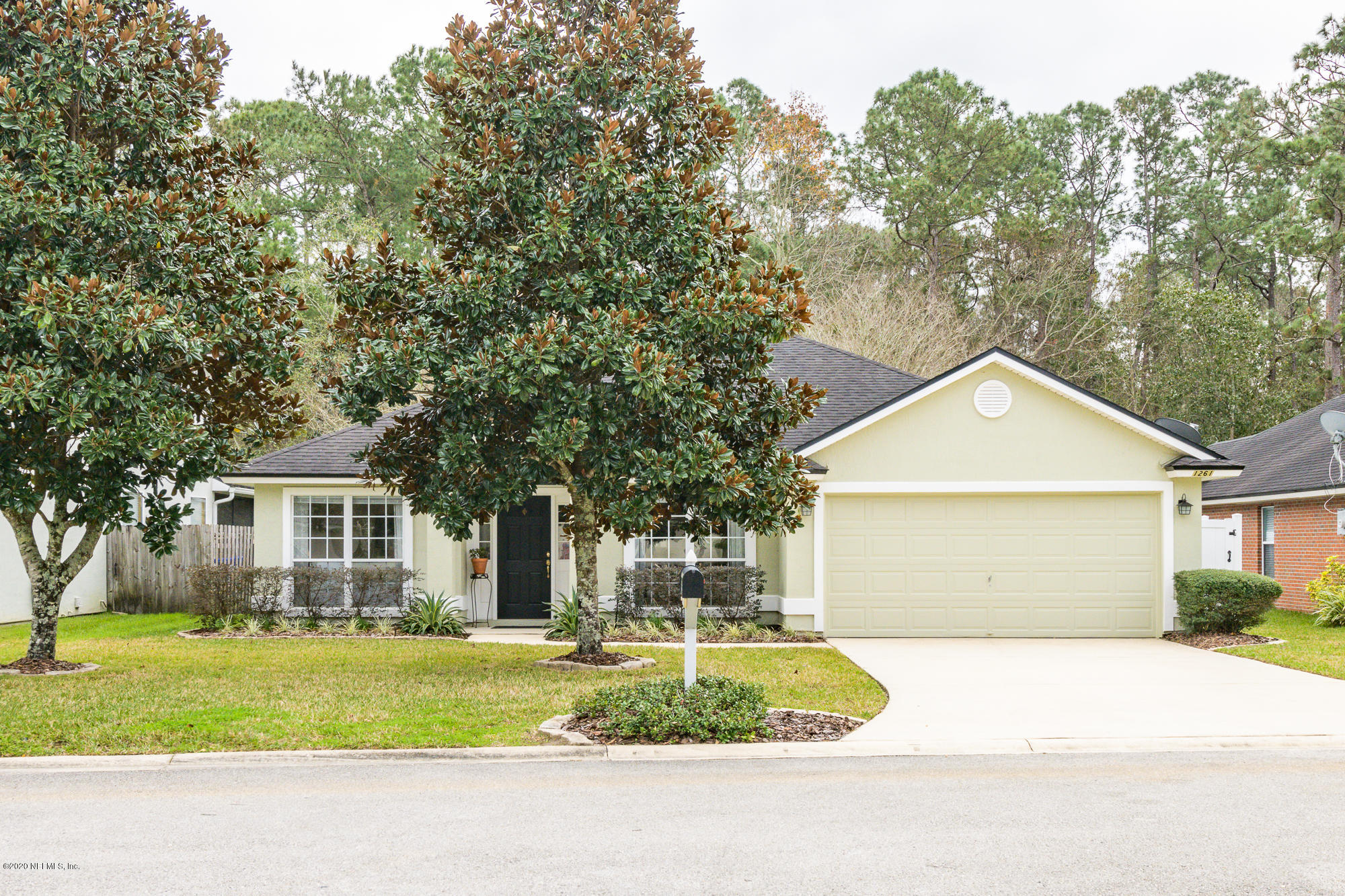 1261 Ribbon Road Jacksonville, FL 32259 - Photo 1 of 33 a front view of a house with a yard and garage