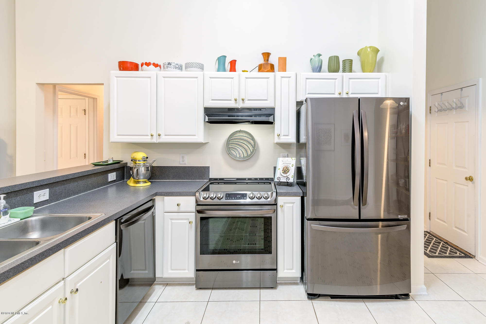 1261 Ribbon Road Jacksonville, FL 32259 - Photo 10 of 33 a kitchen with stainless steel appliances granite countertop a refrigerator a stove and a sink