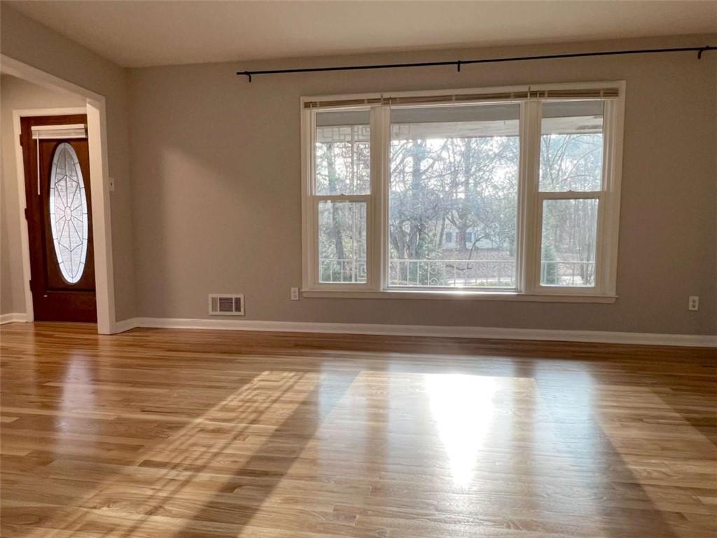 3158 Shabromat Way Atlanta, GA 30341 - Photo 24 of 47 a view of empty room with wooden floor and fan