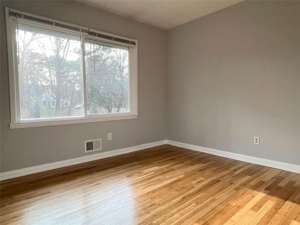 3158 Shabromat Way Atlanta, GA 30341 - Photo 3 of 47 a view of empty room with wooden floor and fan