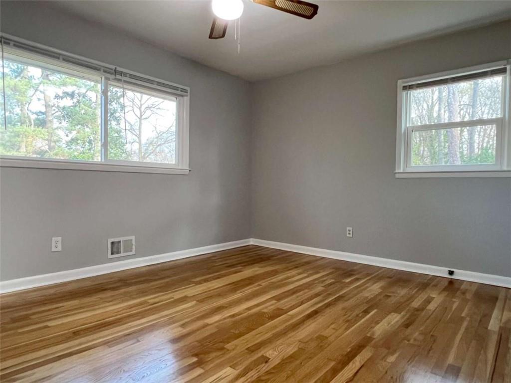 3158 Shabromat Way Atlanta, GA 30341 - Photo 42 of 47 a view of an empty room with a window and wooden floor