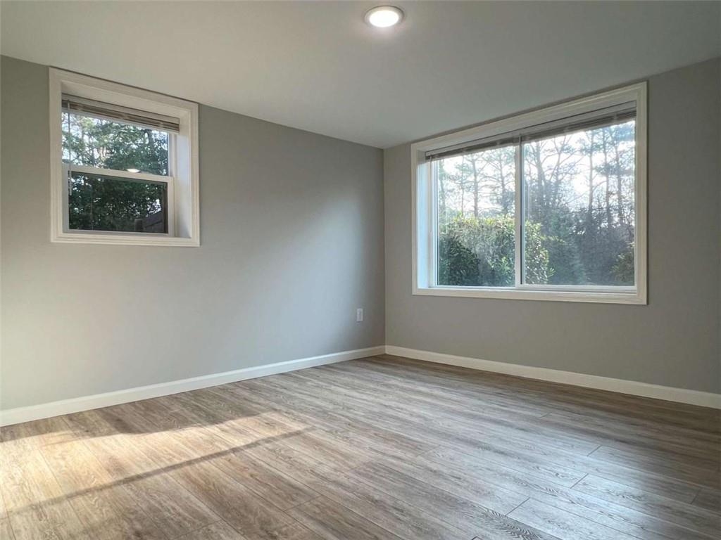 3158 Shabromat Way Atlanta, GA 30341 - Photo 8 of 47 a view of an empty room with wooden floor and a window