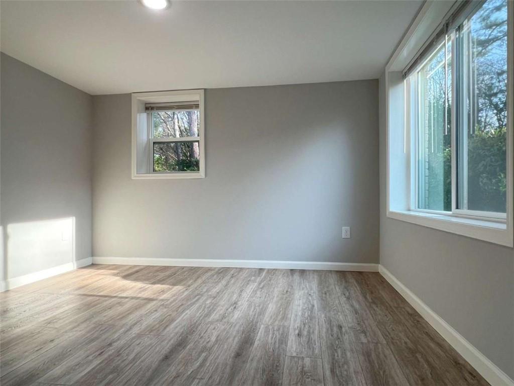 3158 Shabromat Way Atlanta, GA 30341 - Photo 9 of 47 wooden floor in an empty room with a window