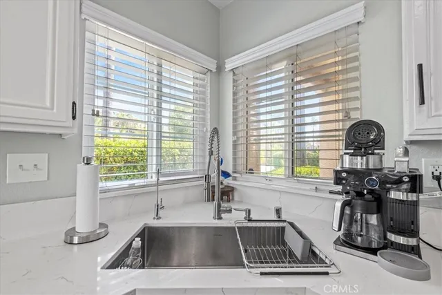 a kitchen with a sink a counter and cabinets