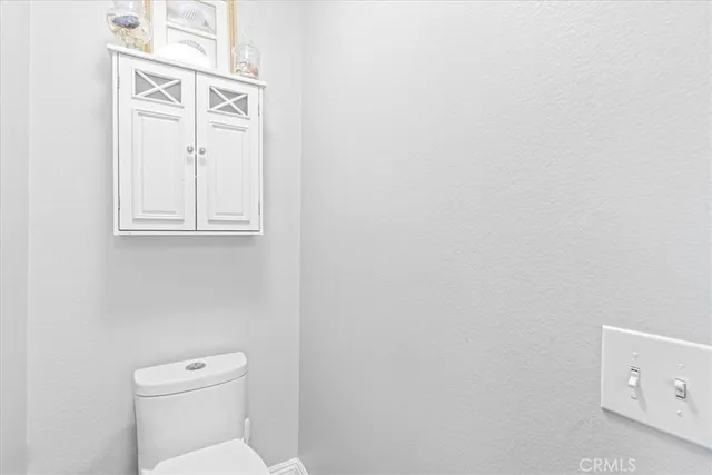 a white toilet sitting next to a bathroom sink