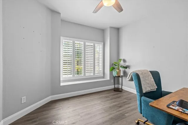 a view of a workspace with furniture and a window