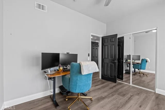 a view of a workspace with furniture and wooden floor