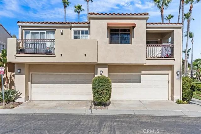 a front view of a house with potted plants