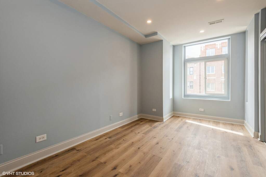 1446 West Irving Park Road, Unit 2 Chicago, IL 60613 - Photo 12 of 23 a view of an empty room with wooden floor and a window