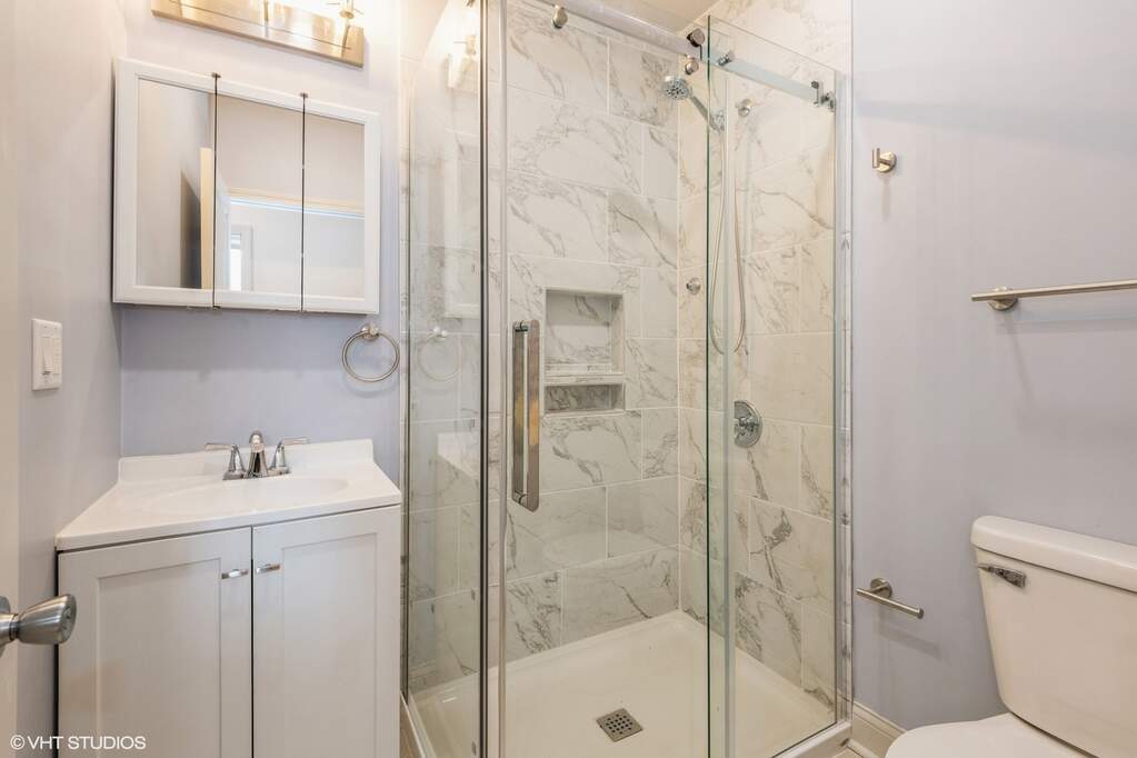 1446 West Irving Park Road, Unit 2 Chicago, IL 60613 - Photo 16 of 23 a bathroom with a sink toilet and shower