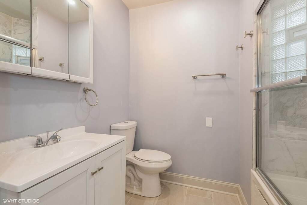 1446 West Irving Park Road, Unit 2 Chicago, IL 60613 - Photo 17 of 23 a bathroom with a sink a toilet and a shower