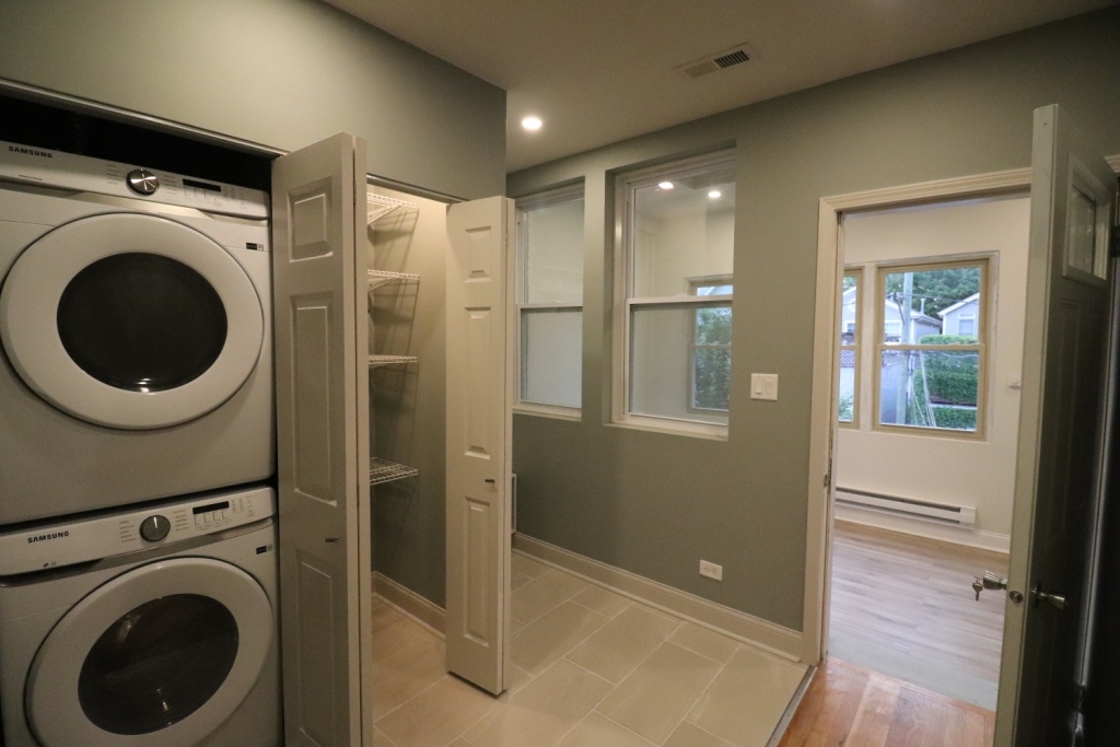 1446 West Irving Park Road, Unit 2 Chicago, IL 60613 - Photo 21 of 23 a view of a hallway with washer and dryer