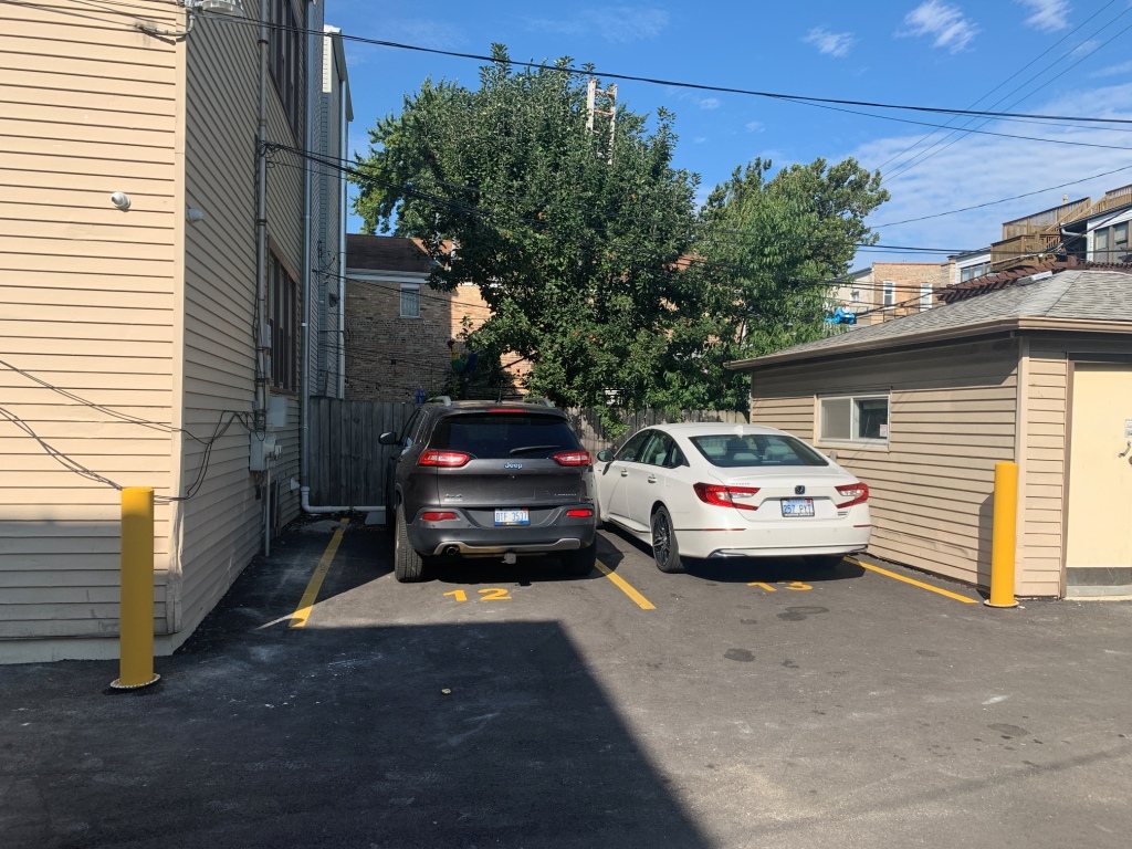 1446 West Irving Park Road, Unit 2 Chicago, IL 60613 - Photo 23 of 23 a front view of a house with parking area