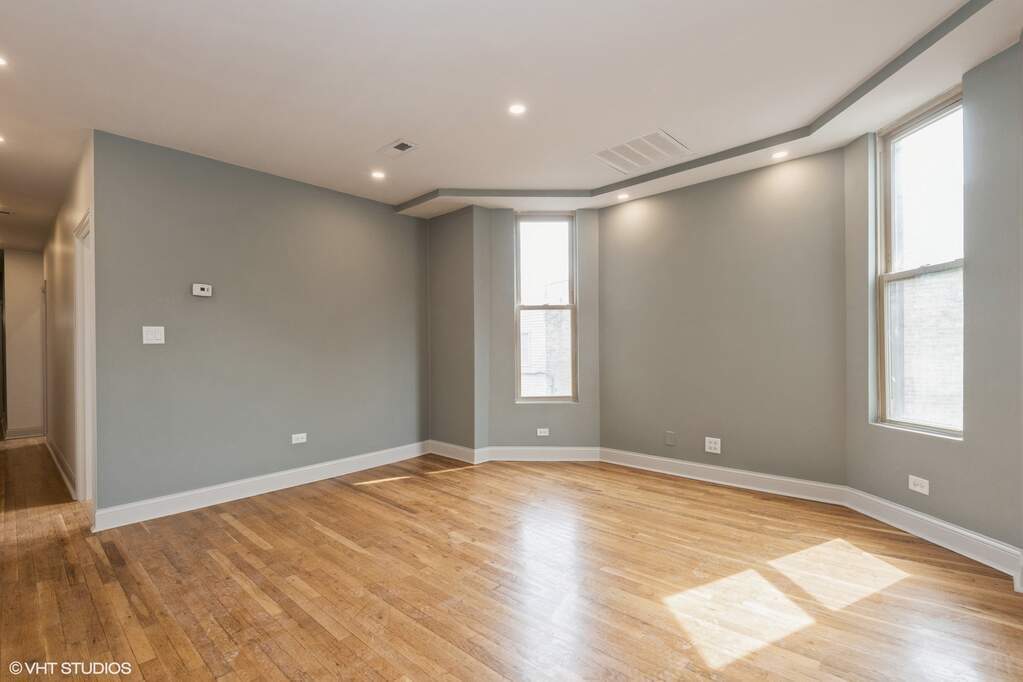 1446 West Irving Park Road, Unit 2 Chicago, IL 60613 - Photo 6 of 23 a view of empty room with wooden floor and fan