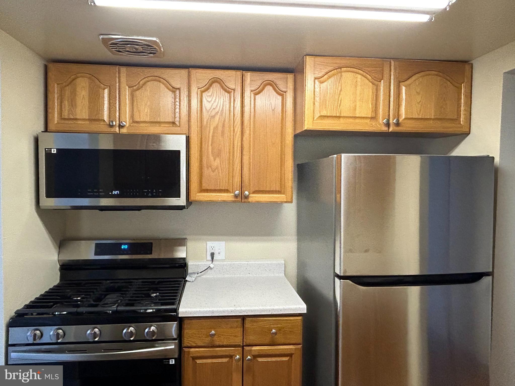 115 Drummers Lane Wayne, PA 19087 - Photo 6 of 11 a kitchen with a refrigerator a stove a sink and a window