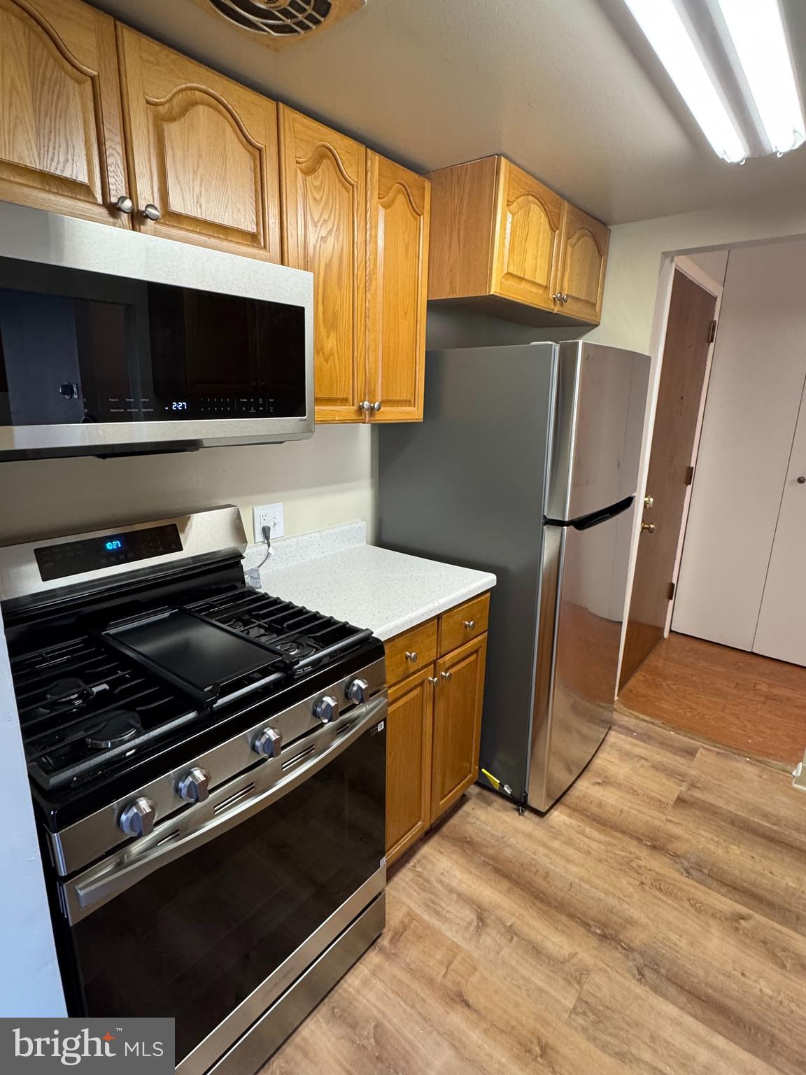 115 Drummers Lane Wayne, PA 19087 - Photo 7 of 11 a kitchen with wooden cabinets and a stove top oven
