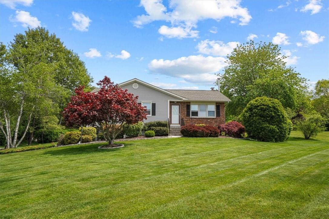 a front view of house with yard and green space