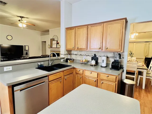a kitchen with a sink stove and cabinets