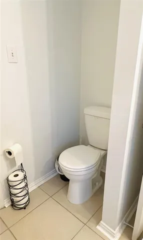 a bathroom with a toilet and a window