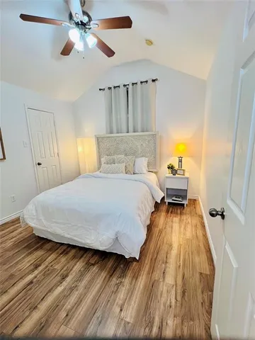 a bedroom with a bed and wooden floor