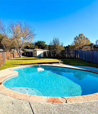 a view of a swimming pool with an outdoor space and seating area
