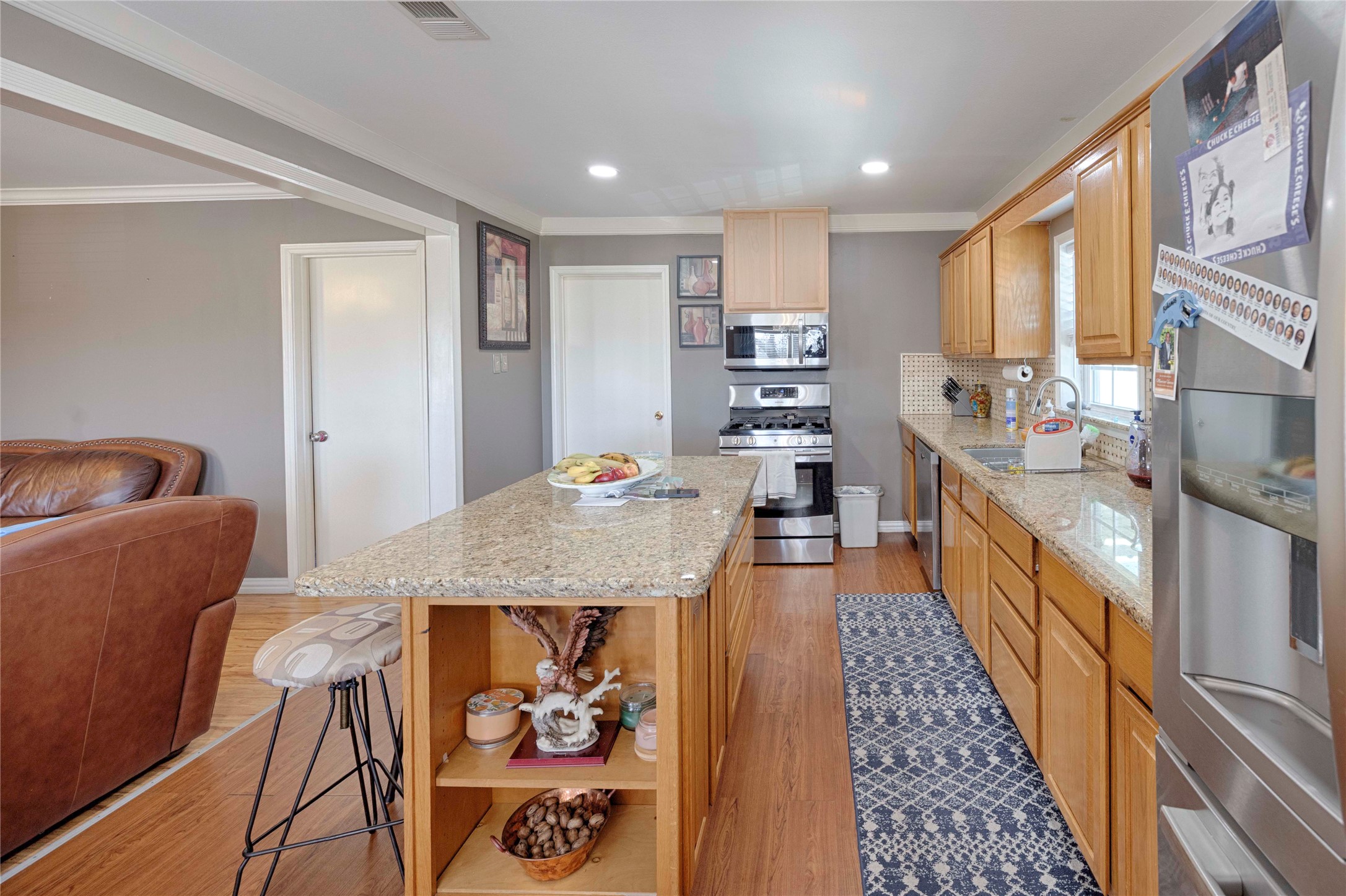 5135 Highway 90 Schulenburg, TX 78956 - Photo 14 of 32 a large kitchen with stainless steel appliances granite countertop a lot of counter space and wooden floor