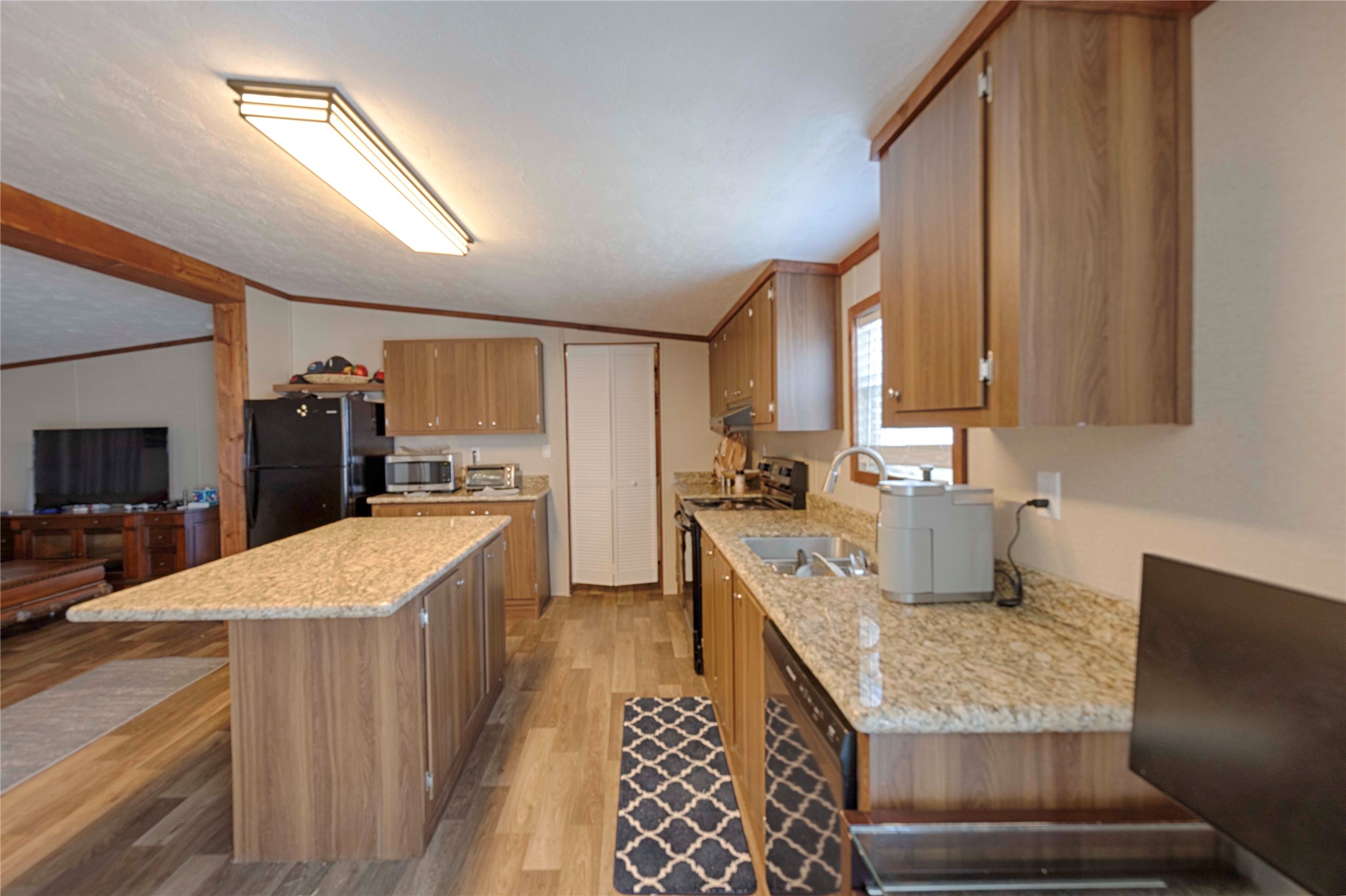 5135 Highway 90 Schulenburg, TX 78956 - Photo 28 of 32 a kitchen with stainless steel appliances granite countertop sink stove refrigerator and cabinets