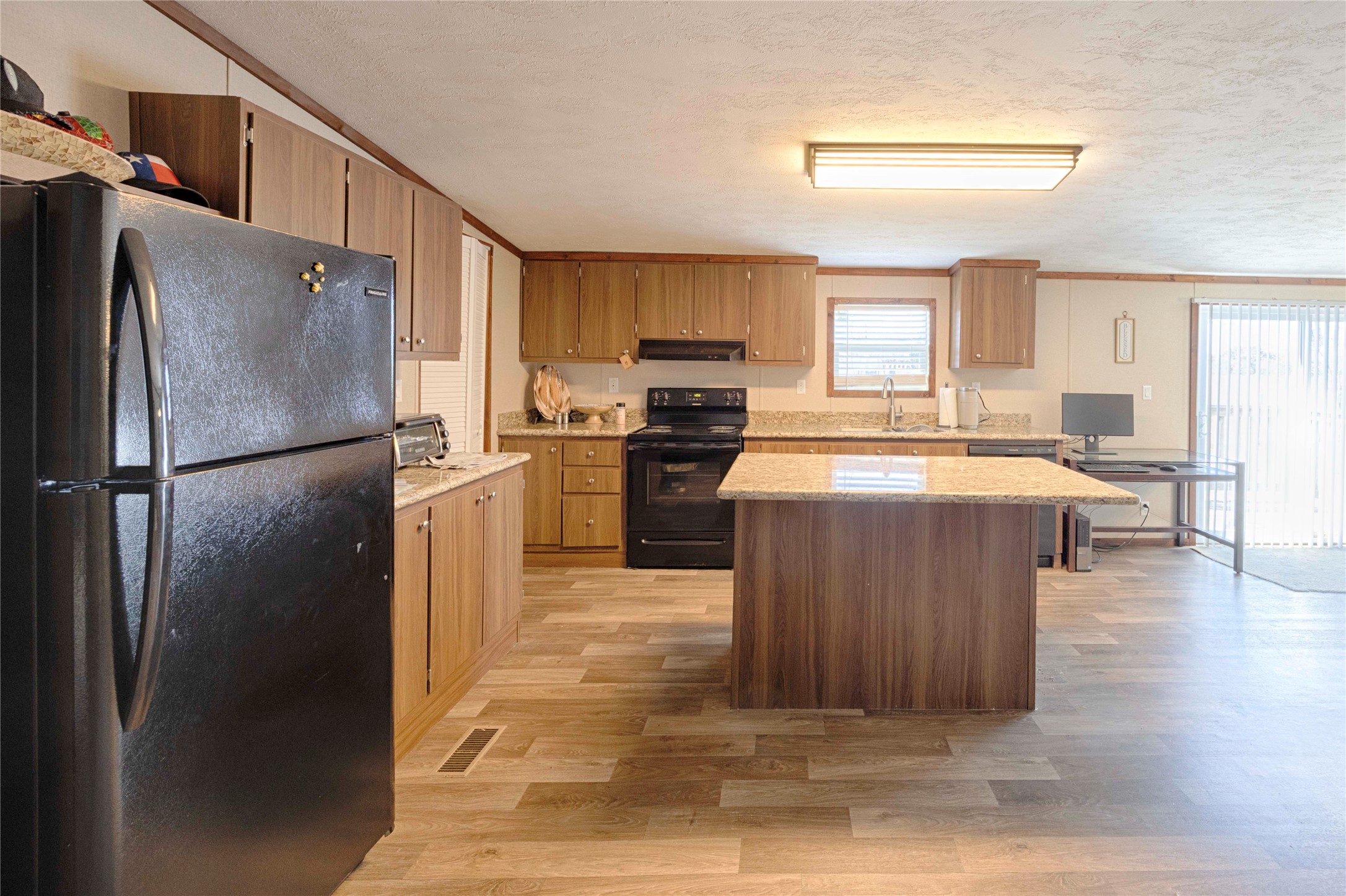 5135 Highway 90 Schulenburg, TX 78956 - Photo 29 of 32 a kitchen with stainless steel appliances granite countertop a refrigerator a stove and a sink
