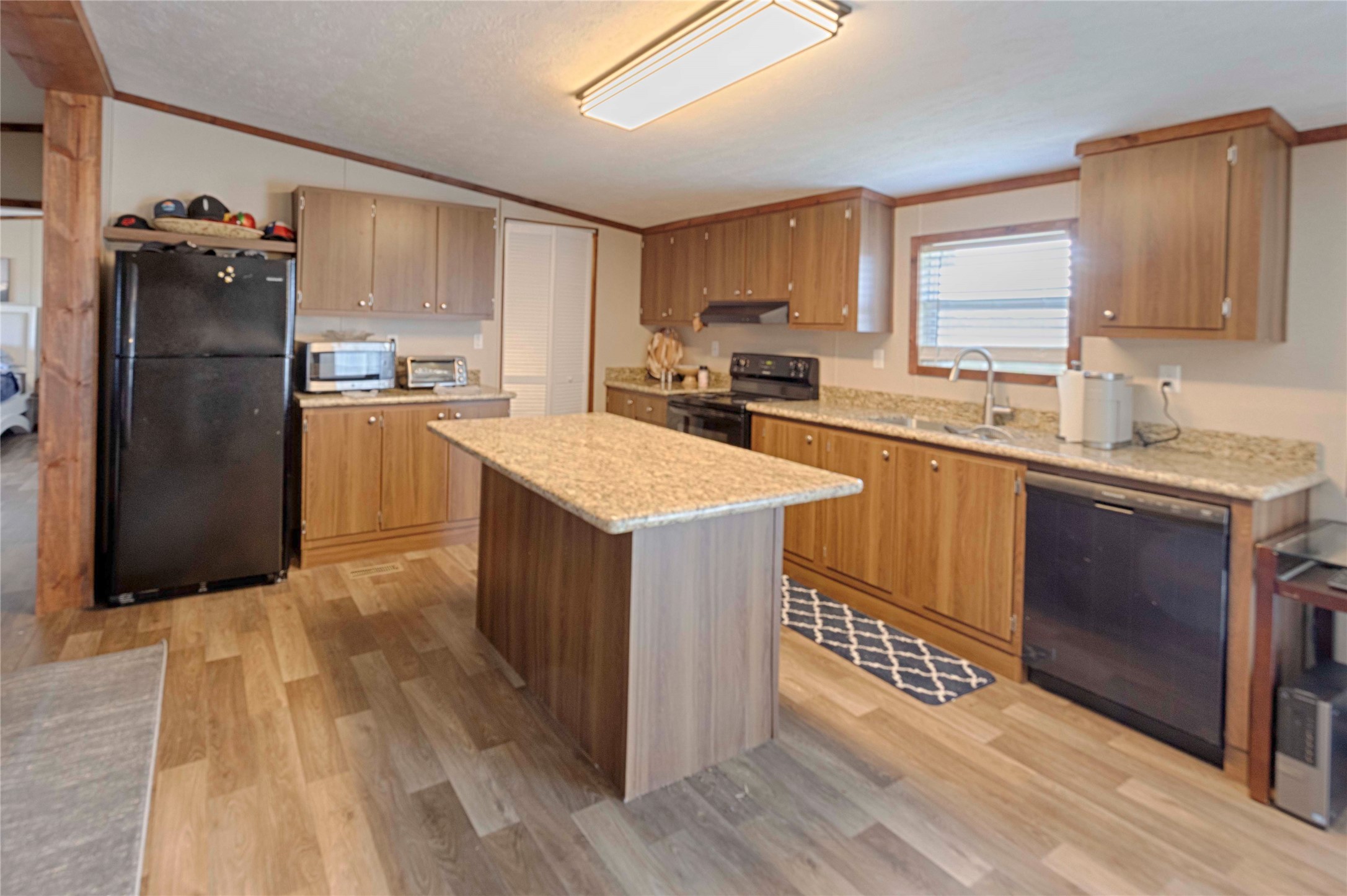 5135 Highway 90 Schulenburg, TX 78956 - Photo 30 of 32 a kitchen with a sink a counter top space stainless steel appliances and cabinets