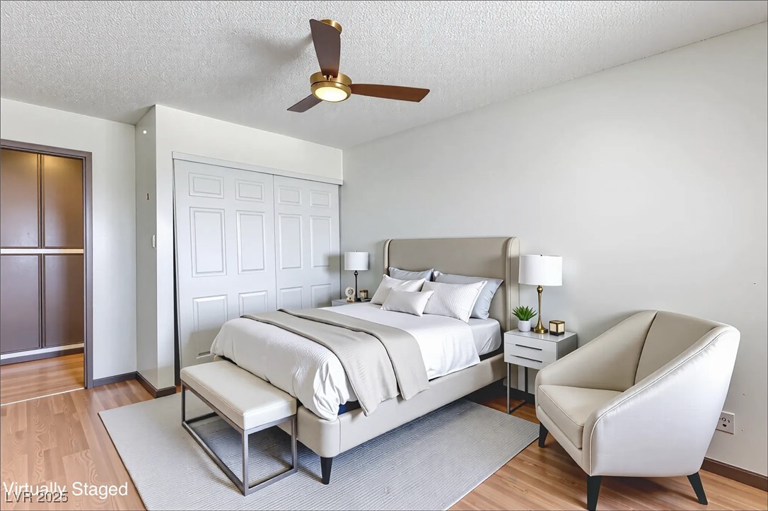 5404 South Swenson Street, Unit 34 Las Vegas, NV 89119 - Photo 11 of 28 Bedroom with light wood finished floors, a textured ceiling, ceiling fan, and a closet