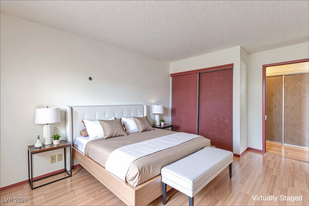 5404 South Swenson Street, Unit 34 Las Vegas, NV 89119 - Photo 15 of 28 Bedroom featuring light wood finished floors, a textured ceiling, and a closet