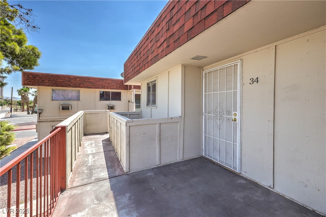 5404 South Swenson Street, Unit 34 Las Vegas, NV 89119 - Photo 28 of 28 Doorway to property featuring a shingled roof and mansard roof