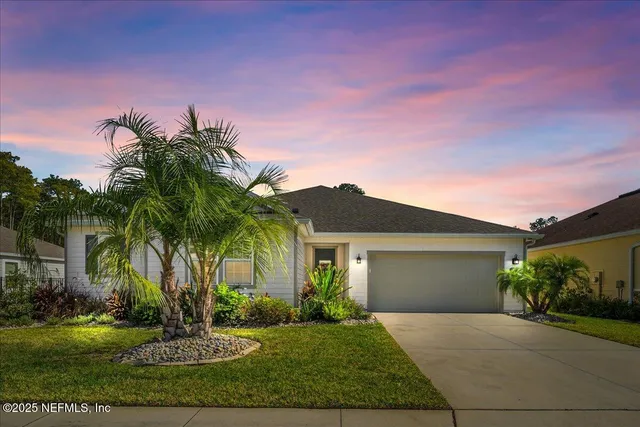 a front view of a house with a garden and yard