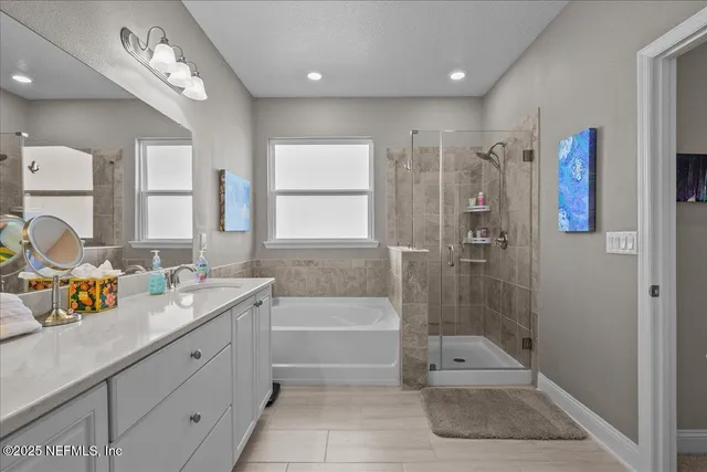 a bathroom with a tub sink toilet and mirror