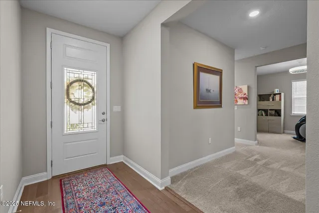 a view of an empty room with window and bathroom