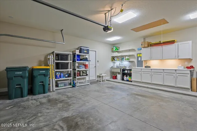 a view of a kitchen with refrigerator and a kitchen view