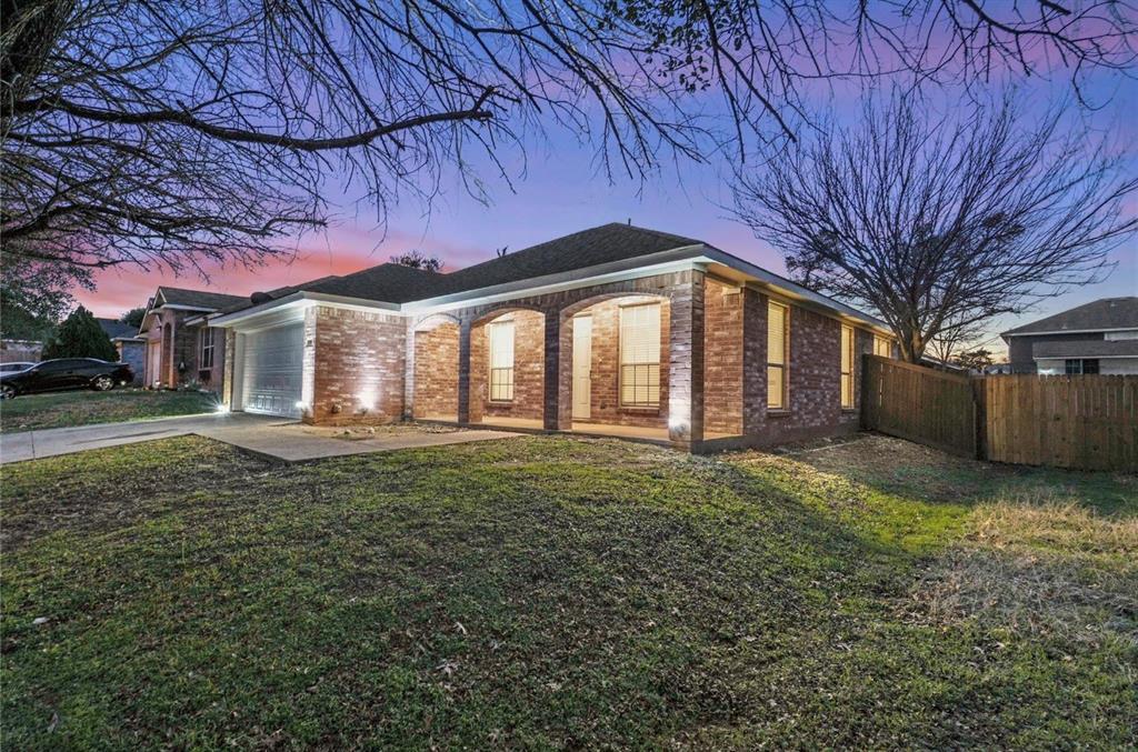 5169 East Rim Road Dallas, TX 75211 - Photo 1 of 19 Brick exterior with a covered porch featuring arched entries