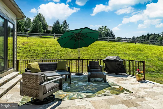 a kitchen with kitchen island granite countertop a sink cabinets and stainless steel appliances