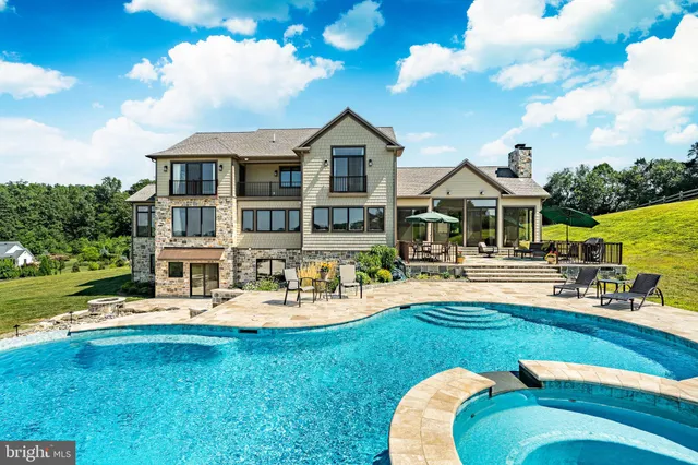 a dining room with furniture a chandelier and wooden floor