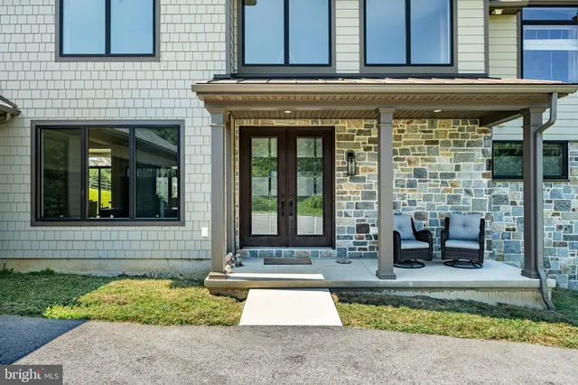 a bedroom with furniture and a large window