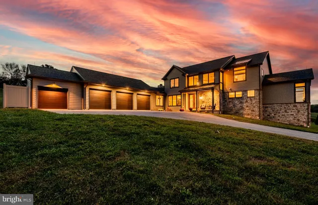 a view of a house with swimming pool and sitting area