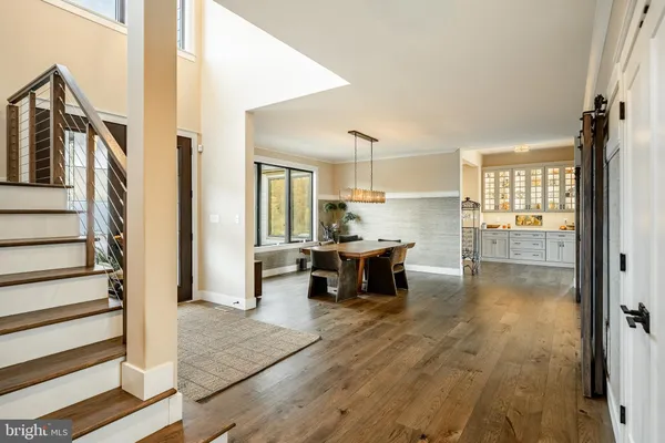 a large kitchen with a lot of counter space and wooden floor
