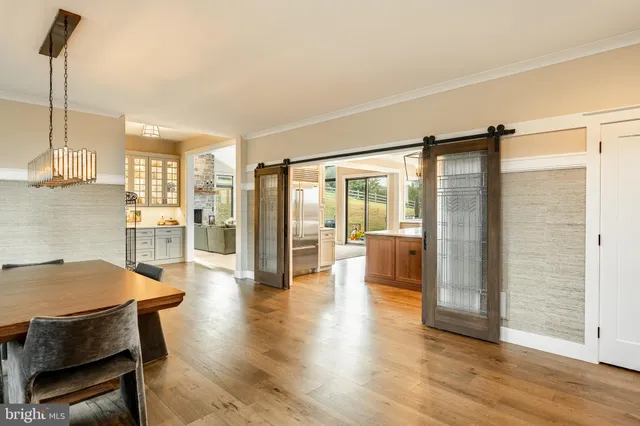 a living room with furniture a desk and chair with wooden floor