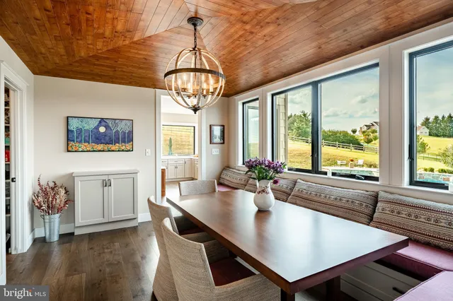 a view of a livingroom with workspace and a large window
